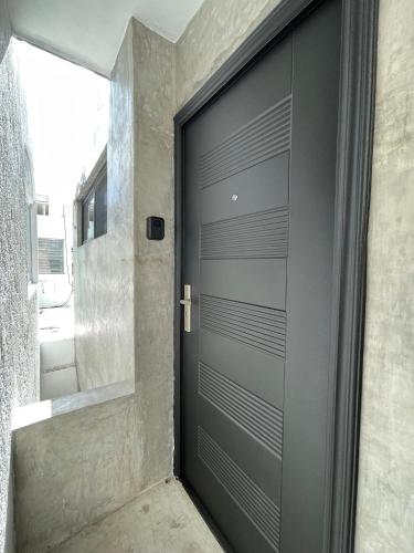 a black garage door in a room with a window at Casa y departamentos lavanda in Mérida