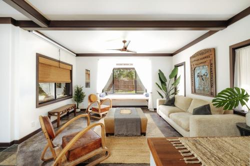 a living room with a couch and a table at The Bamboo House in Kailua-Kona