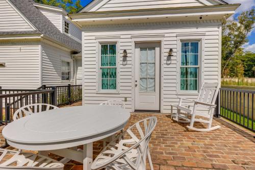 a white table and chairs on a brick patio at Luxe Fairhope Home with Covered Patio Walk to Bay in Fairhope