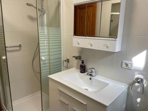 a bathroom with a sink and a shower at TAGARA - 2 pools, ocean view, Puerto de Santiago in Puerto de Santiago