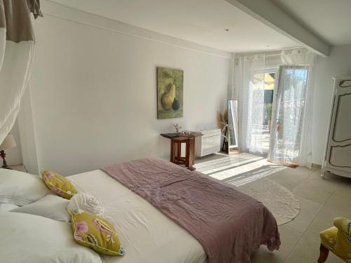 a bedroom with a bed and a door to a patio at B&B Villa Ganesh in Le Rouret