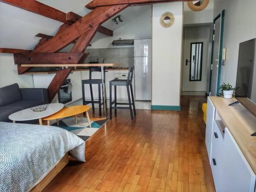 ein Zimmer mit einem Bett und eine Küche mit einem Tisch in der Unterkunft Cœur de ville avec parking+gare à proximité de Disney et Paris in Lagny