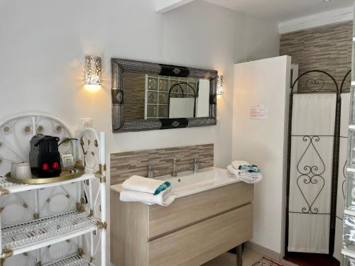 a bathroom with a bath tub and a mirror at B&B Villa Ganesh in Le Rouret