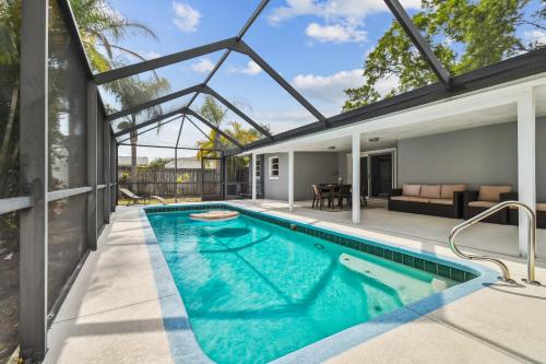 an indoor swimming pool in a house with a patio at Heated Pool! Paradise in Midtown Tampa 3B2B in Tampa