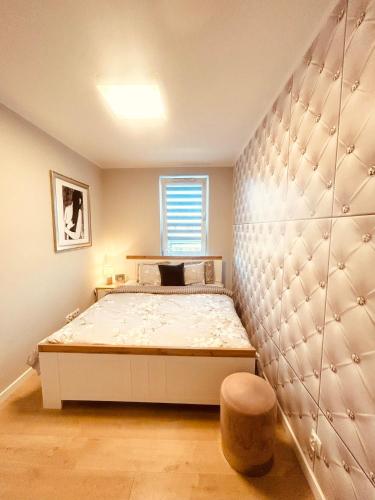 a bedroom with a bed and a window at DowntownApartments Carrie in Rzeszów