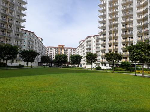 a park with large apartment buildings in the background at FourSphere staycation in Manila