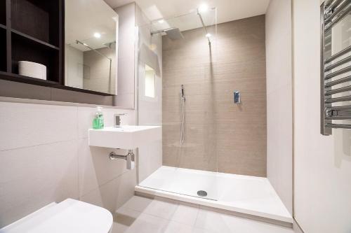 La salle de bains est pourvue d'une douche, de toilettes et d'un lavabo. dans l'établissement Modern, Stylish, Canalside PENTHOUSE Apartment Next to Wembley Stadium!, à Londres