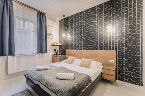Кровать или кровати в номере Apartmanház Soho