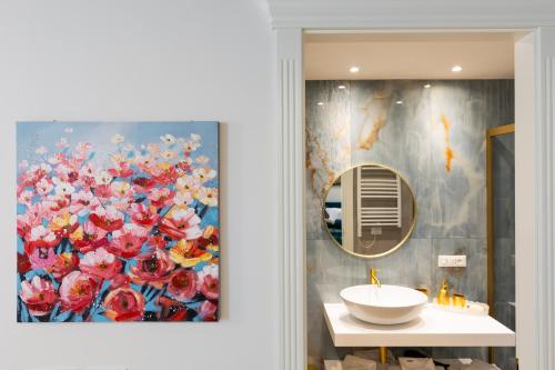 a bathroom with a painting of flowers on the wall at RomeInSuite in Rome