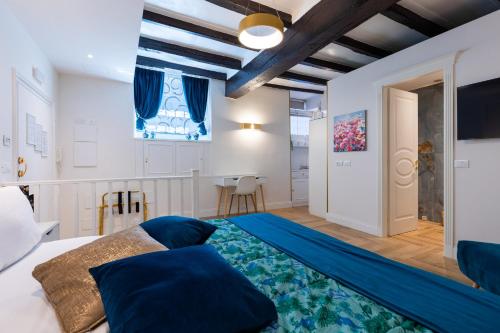 a bedroom with a large bed with blue sheets at RomeInSuite in Rome