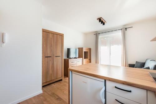 a kitchen with white cabinets and a counter top at HoHome Comfy Apartments in Warsaw