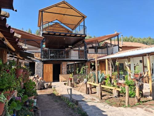 a building with a balcony on top of it at KOSKO Casa Hotel in Cusco