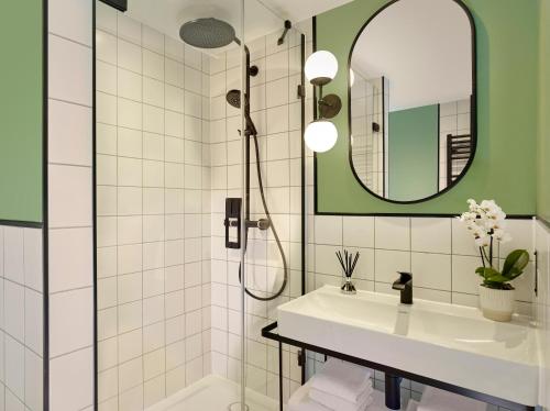 a bathroom with a sink and a shower at Citadines Holborn - Covent Garden London in London