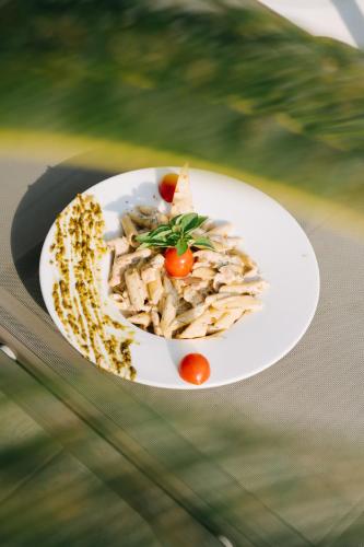 a white plate of food on a glass table at Maye Residence in Gümbet