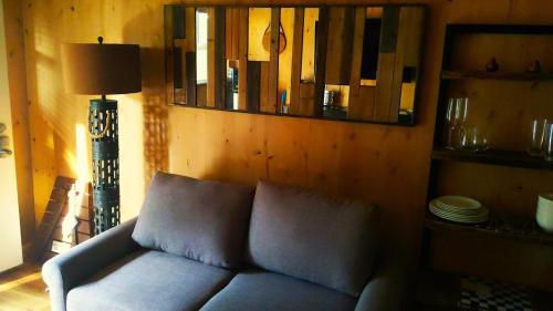 a blue couch in a living room with a mirror at Lazy Bear Cabin 6 - Sleeps Up To 4 
