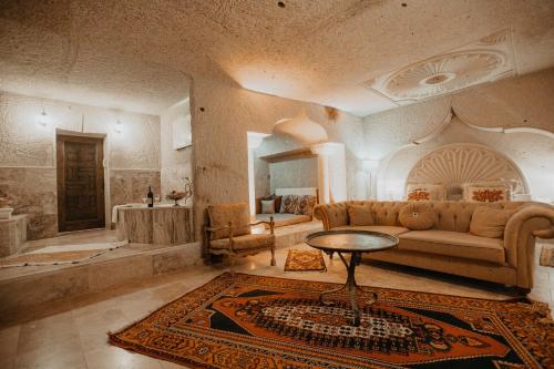 a living room with a couch and a table at Serenus Cave Suites in Ortahisar