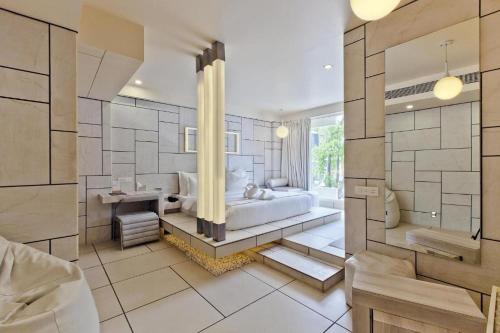 a large bathroom with a tub and a sink at Hotel El Dorado in Ahmedabad