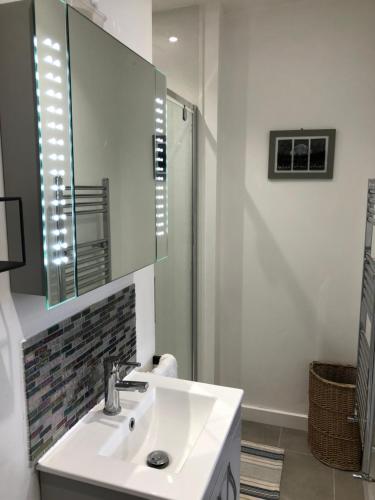 a white bathroom with a sink and a shower at HarbourSide Studio apartment Poole Hamworthy Bh15 in Hamworthy