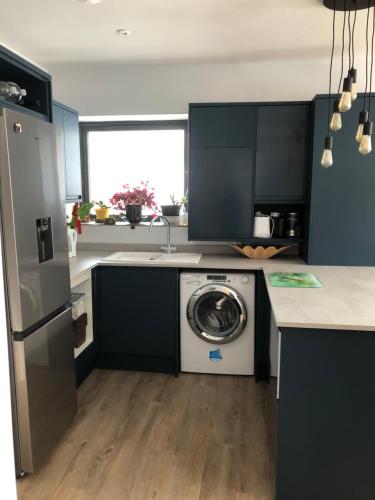 a kitchen with a washing machine in a kitchen at HarbourSide Studio apartment Poole Hamworthy Bh15 in Hamworthy