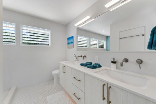 a white bathroom with a sink and a mirror at Ka Hale Olu at Anini Beach TVNC#4218 in Kilauea