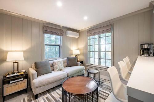 a living room with a couch and a table at Exquisite Bedford Lux Retreat. in Bedford