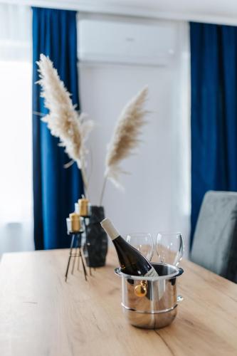 a bottle of wine in a bucket on a table at Modern Lux Apartment 2 in Brčko