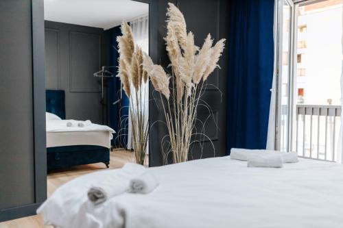 a bedroom with a white bed and a mirror at Modern Lux Apartment 2 in Brčko