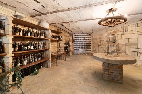 a wine cellar with shelves of wine bottles at Pratolina in Savona