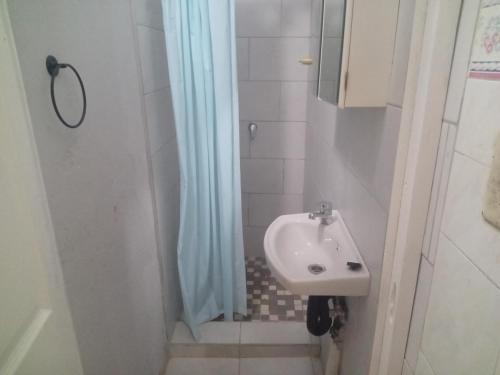 a bathroom with a sink and a shower at Quintax Guest House in Pretoria