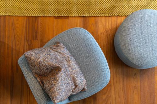 a pillow on top of a chair on a wooden floor at Grand Hotel Torre Fara in Chiavari