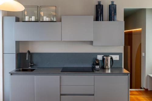 a kitchen with white cabinets and a counter top at Grand Hotel Torre Fara in Chiavari