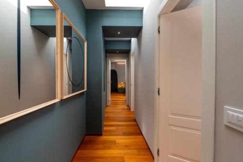 a hallway with blue walls and a mirror at Grand Hotel Torre Fara in Chiavari