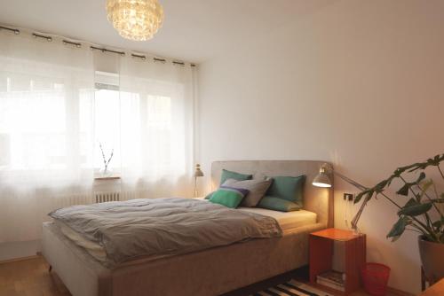 a bedroom with a bed and a large window at Stylish hideout - mountain view in Brixen