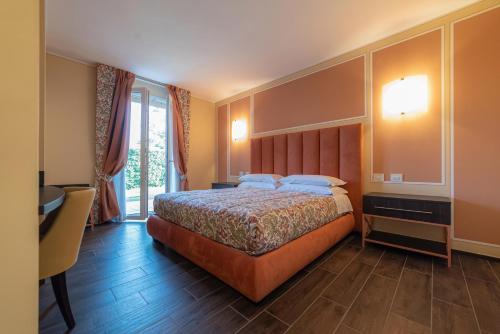 a hotel room with a bed and a window at I Castagni in Vigevano