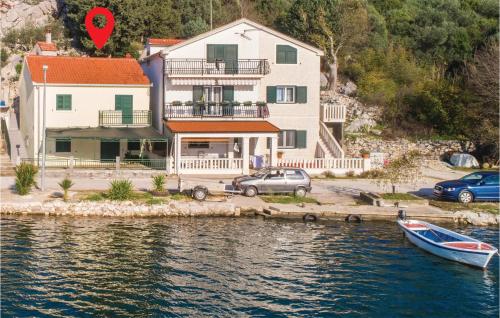 a house by the water with a red heart on it at One-Bedroom Holiday Home In Rogotin in Rogotin