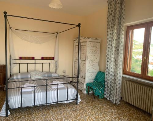 a bedroom with a bed and a chair and a window at The Stunning View in Scala