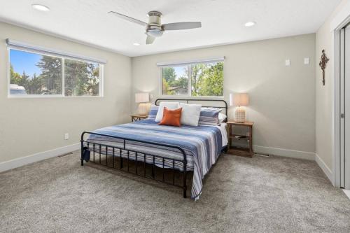 a bedroom with a bed and two windows at Pimlico Pastures in Eagle
