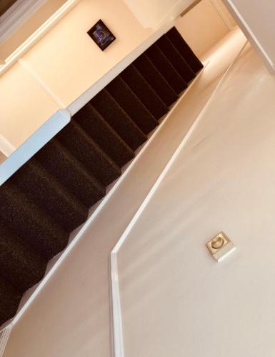 an overhead view of an escalator with a staircase at AC Lounge 36 (Room D) in Rochford