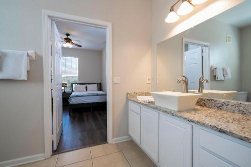 a bathroom with a sink and a mirror at The Best Location! Resort Near All Parks! Int'l Dr in Orlando