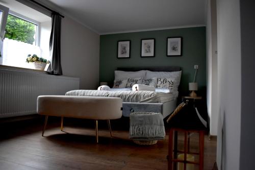 a living room with a couch and a chair at Bakonyi Porta Olaszfalu in Olaszfalu