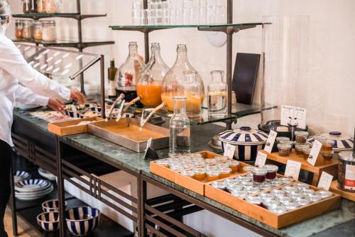 a chef preparing food on a counter in a kitchen at Romantikhotel Rebstock art & design in Kehl am Rhein