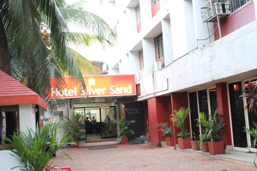 a building with a sign for a sweetener stand at Hotel Silver Sand in Trivandrum