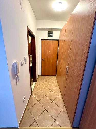 a hallway with a door and a tile floor at Apartment Stex 3 in Podgorica
