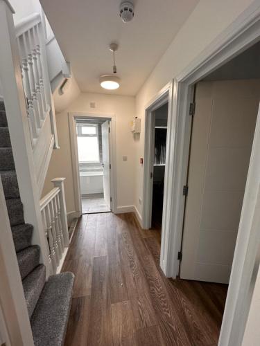 a hallway of a home with stairs and a door at Lovely Hillingdon Family Holiday Home - 6 bedrooms in Ickenham