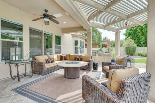 a patio with furniture and a ceiling fan at Day Trip to Dtwn Phoenix Peoria Retreat with Pool in Peoria