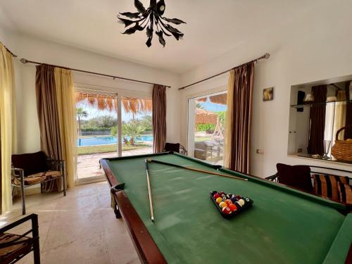 a pool table in a living room with a pool at GS 23 in Hurghada