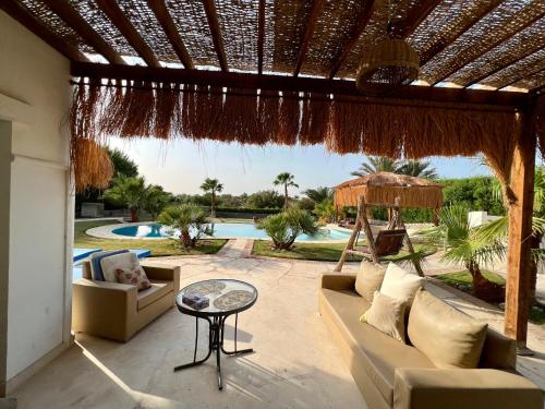 a patio with a couch and a table and a pool at GS 23 in Hurghada