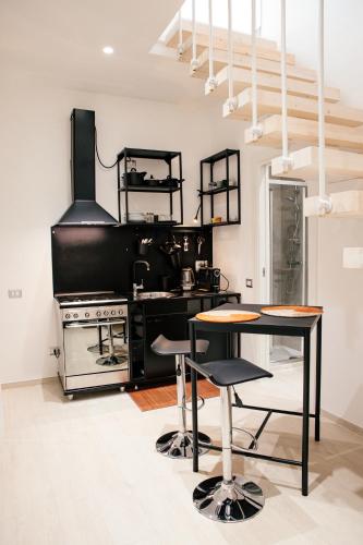 a kitchen with a stove and a table at Bed and Breakfast Le Foglie in Altamura