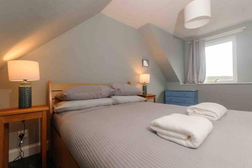 a bedroom with two beds with white towels on them at Stunning House near Fort William - Taigh Sona in Spean Bridge