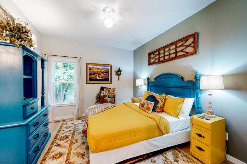 a bedroom with a bed and a blue cabinet at NOLA on Main in Eureka Springs